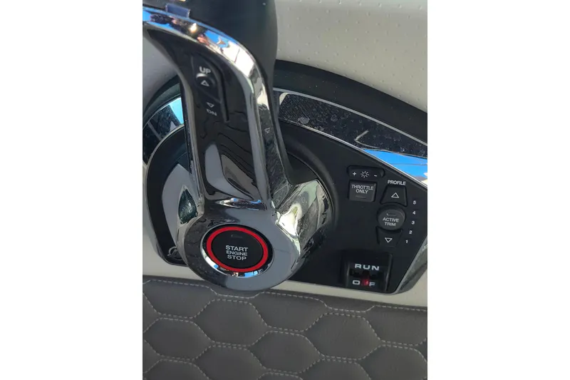 Slide: The Image of 2024 Sea Ray SDX 250 Outboard throttle control with start/stop button and trim settings. - 36