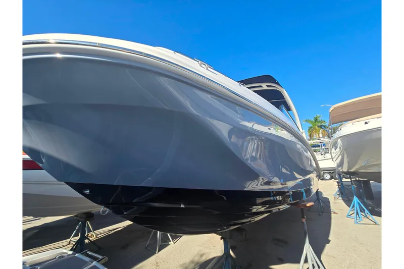Slide: The Image of 2024 Sea Ray SDX 250 Outboard boat on display under clear blue sky. - 38