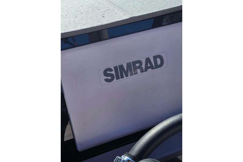Slide: The Image of 2024 Sea Ray SDX 250 Outboard dashboard featuring Simrad electronics. - 40