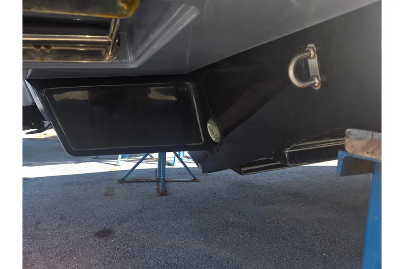 Slide: The Image of Underside of a 2024 Sea Ray SDX 250 Outboard boat on a stand. - 46