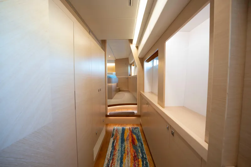 Slide: The Image of Luxurious interior hallway of 2016 Horizon PC52 yacht with modern design and vibrant rug. - 15