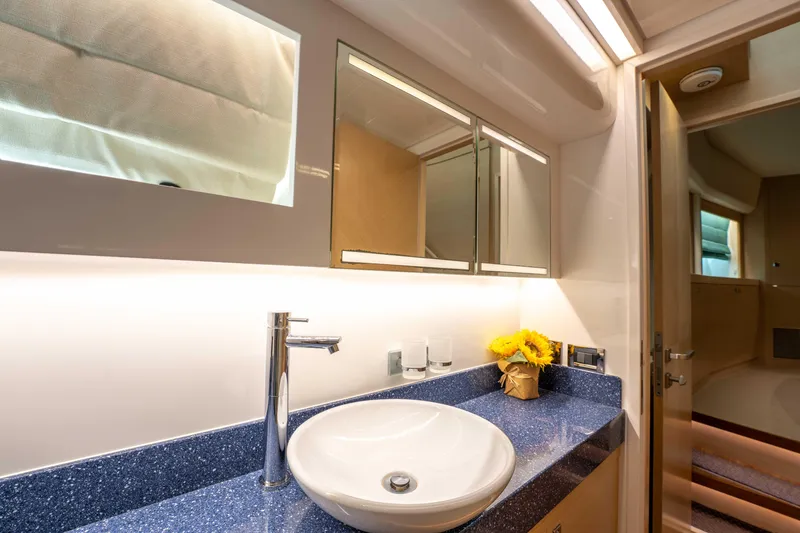 Slide: The Image of Luxurious bathroom in 2016 Horizon PC52 yacht with modern sink and sunflowers. - 28