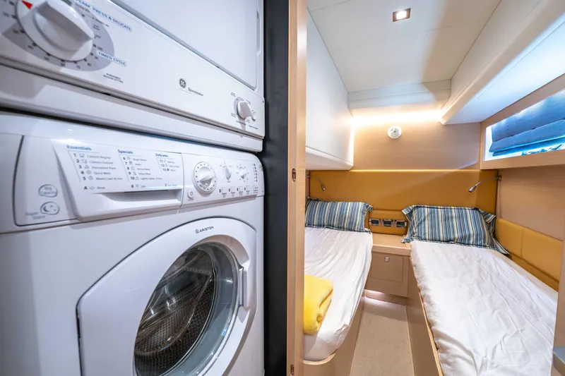 Slide: The Image of Laundry area and twin bedroom in 2016 Horizon PC52 yacht interior. - 32