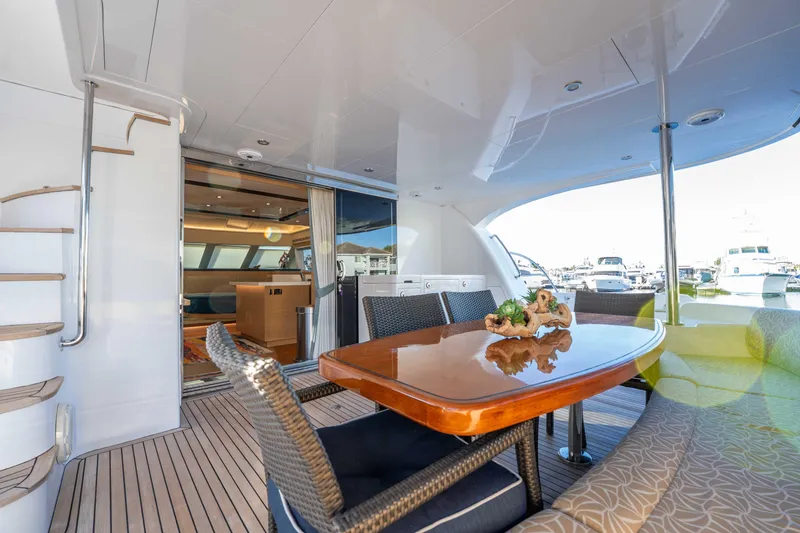 Slide: The Image of Luxurious 2016 Horizon PC52 yacht deck with elegant dining area and marina view. - 40