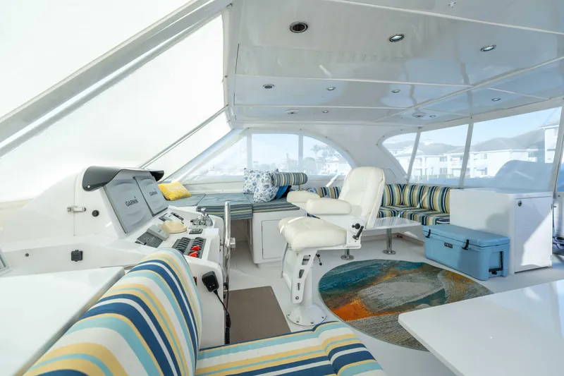 Slide: The Image of Luxurious interior of 2016 Horizon PC52 yacht with striped seating and modern helm. - 44
