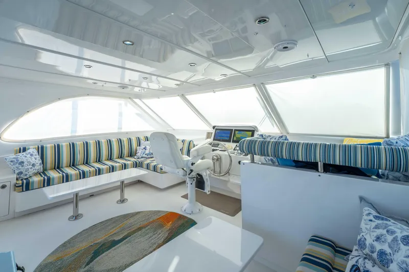Slide: The Image of Luxurious interior of 2016 Horizon PC52 yacht with striped seating and modern helm. - 45