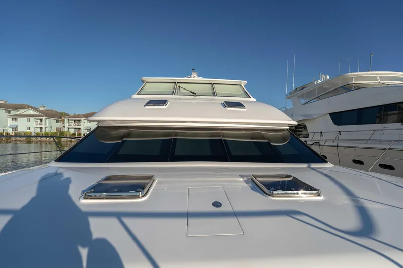Slide: The Image of 2016 Horizon PC52 yacht front view with clear blue sky background. - 48
