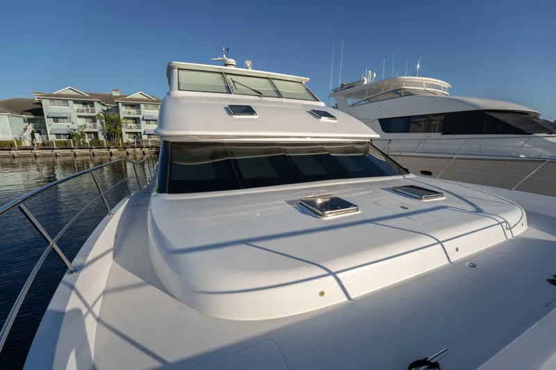 Slide: The Image of 2016 Horizon PC52 yacht docked near waterfront buildings under clear blue sky. - 49