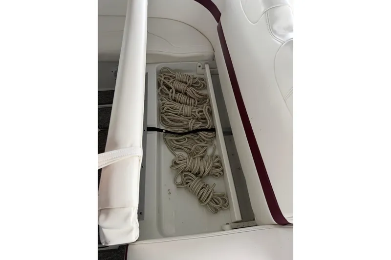 Slide: The Image of Storage compartment with coiled ropes in a 2007 Formula 310 Sun Sport boat. - 15