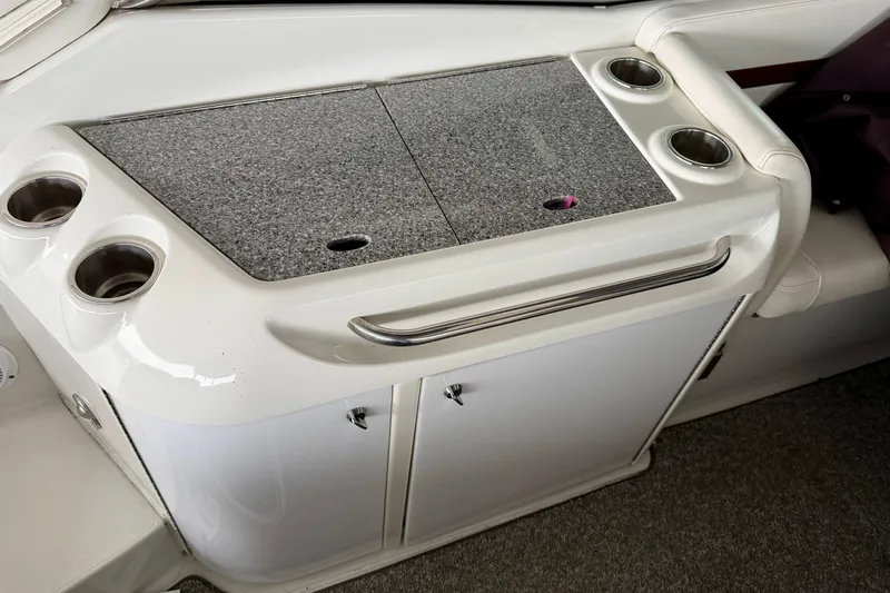 Slide: The Image of 2007 Formula 310 Sun Sport boat interior with cup holders and storage cabinet. - 18