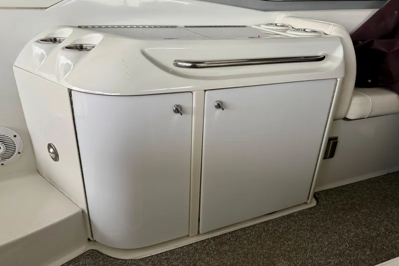 Slide: The Image of 2007 Formula 310 Sun Sport boat interior with storage cabinet and cup holders. - 19