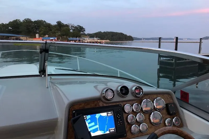Slide: The Image of 2007 Formula 310 Sun Sport boat dashboard with navigation system, docked at serene lake. - 27