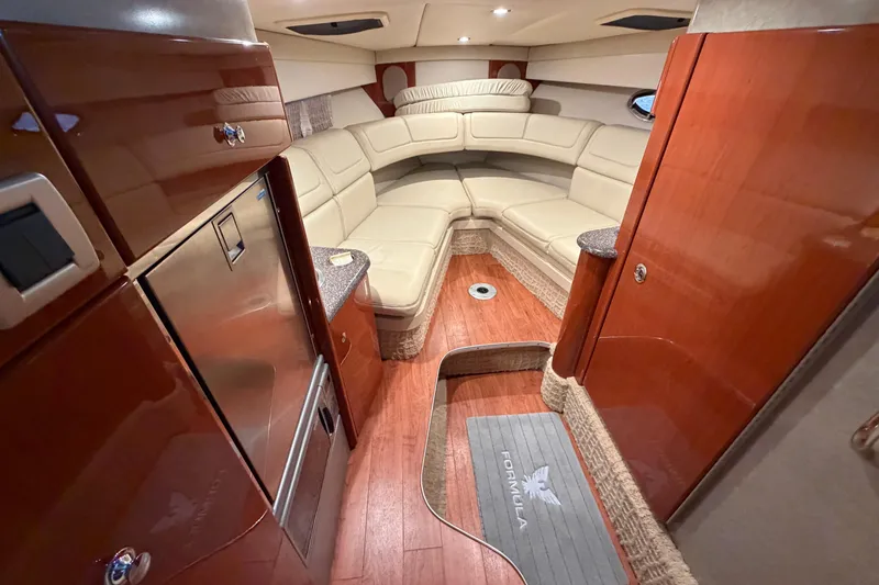 Slide: The Image of Luxurious interior of 2007 Formula 310 Sun Sport boat with plush seating and wood finishes. - 30