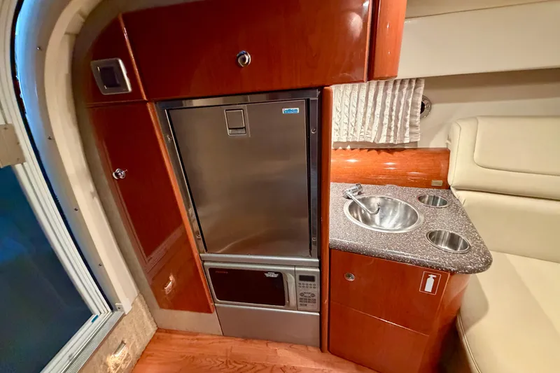 Slide: The Image of 2007 Formula 310 Sun Sport interior with kitchenette, featuring sink and refrigerator. - 34
