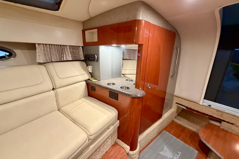 Slide: The Image of Interior of 2007 Formula 310 Sun Sport boat with beige seating and wooden cabinetry. - 36