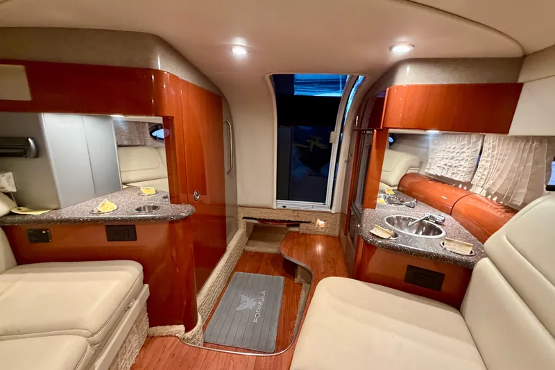 Slide: The Image of Luxurious interior of a 2007 Formula 310 Sun Sport boat with wood finishes and seating. - 39
