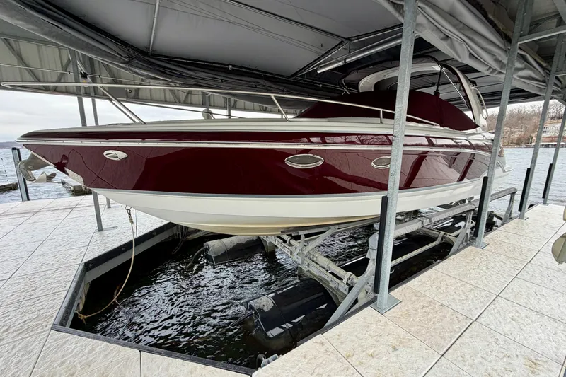 Slide: The Image of 2007 Formula 310 Sun Sport boat docked on a lift under a canopy. - 7