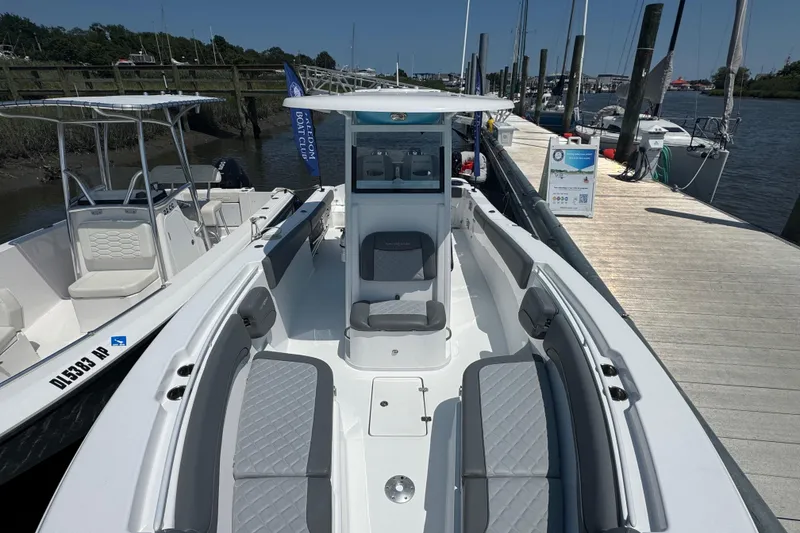 Slide: The Image of 2025 NauticStar 292 Legacy boat docked, showcasing spacious seating and sleek design. - 3