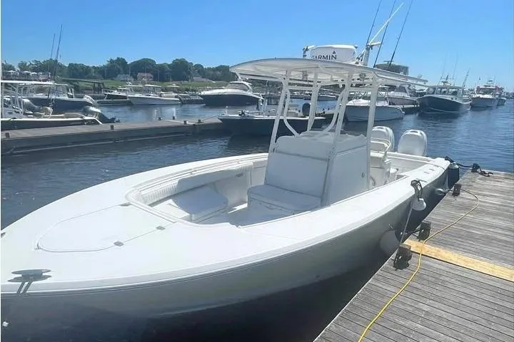 Slide: The Image of 2005 Southport 26 Center Console boat docked at a marina on a sunny day. - 1