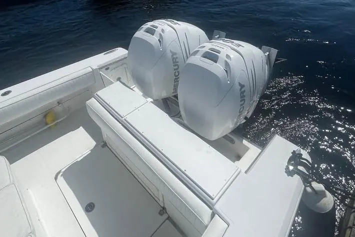 Slide: The Image of 2005 Southport 26 Center Console boat with twin Mercury outboard engines on water. - 2