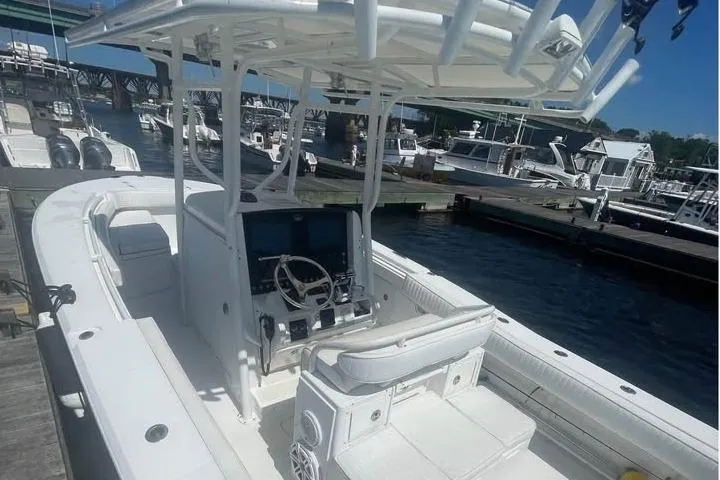 Slide: The Image of 2005 Southport 26 Center Console boat docked at marina, featuring spacious seating and helm. - 3