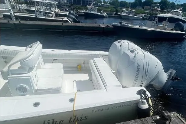 Slide: The Image of 2005 Southport 26 Center Console boat docked with twin Mercury engines. - 6