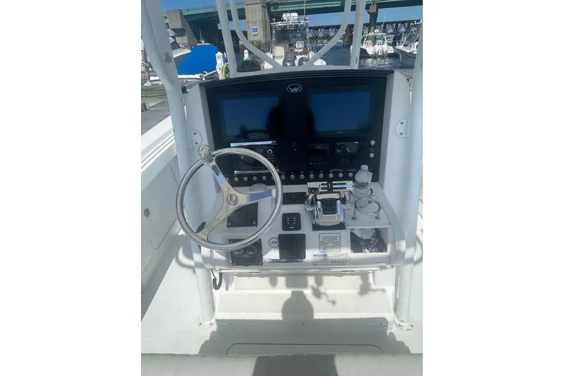 Slide: The Image of 2005 Southport 26 Center Console boat dashboard with steering wheel and controls. - 7