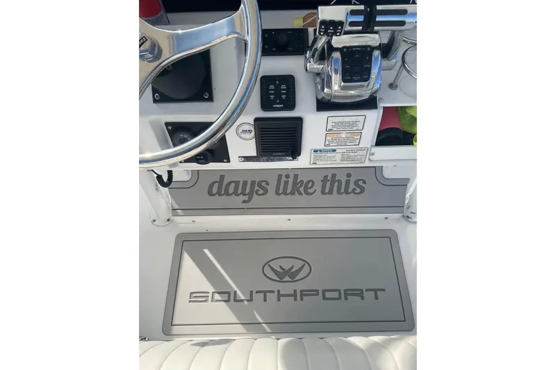 Slide: The Image of Center console of a 2005 Southport 26, featuring steering wheel and controls. - 8