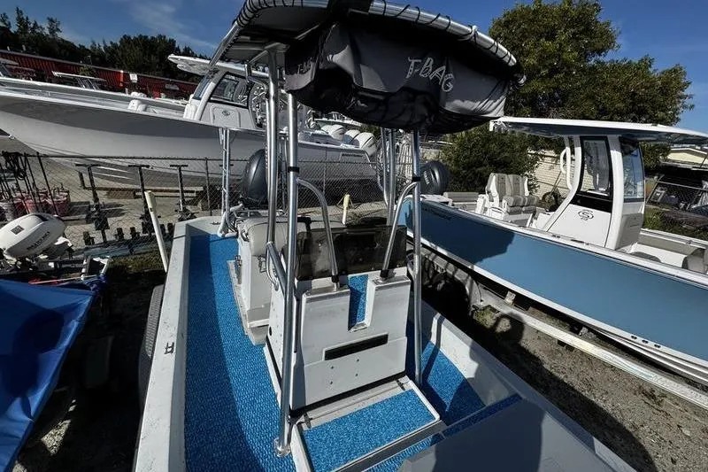 Slide: The Image of 2001 Gulf Coast 200 boat with T-top, docked among other boats. - 13
