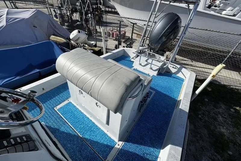 Slide: The Image of 2001 Gulf Coast 200 boat interior with blue flooring and gray seating. - 14