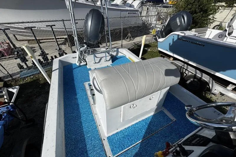 Slide: The Image of 2001 Gulf Coast 200 boat interior with blue flooring and seating. - 15