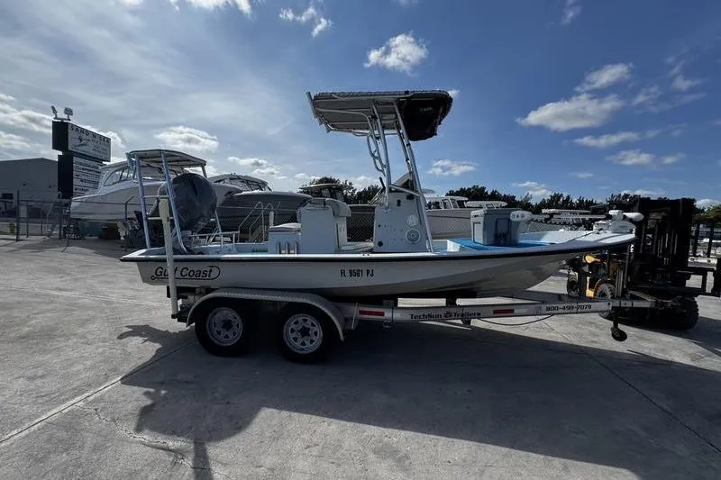 Slide: The Image of 2001 Gulf Coast 200 boat on trailer under blue sky. - 6