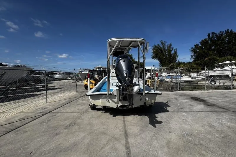Slide: The Image of 2001 Gulf Coast 200 boat in a marina storage area under clear blue skies. - 7