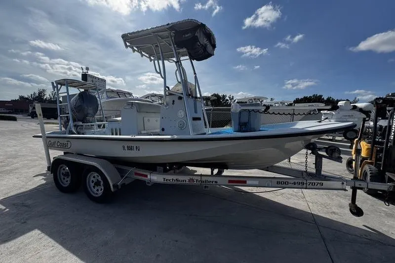 Slide: The Image of 2001 Gulf Coast 200 boat on trailer under clear sky. - 8