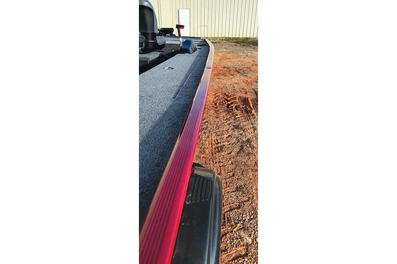 Slide: The Image of 2026 Tracker Panfish 17 boat, side view with red trim and textured surface. - 15