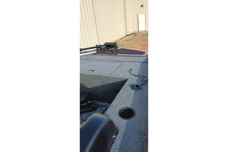 Slide: The Image of 2026 Tracker Panfish 17 boat deck with fishing rod holder and storage compartments. - 17