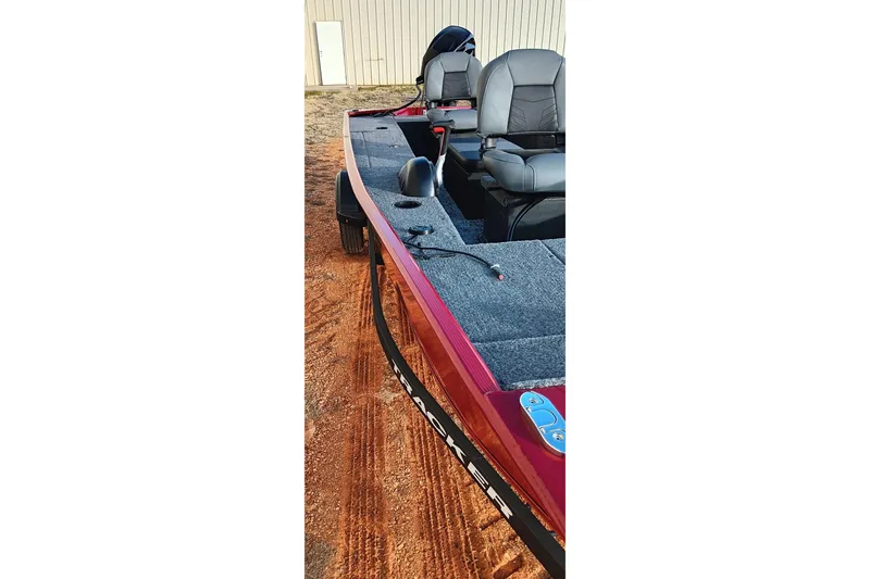 Slide: The Image of 2026 Tracker Panfish 17 boat with dual seats on a sandy surface. - 2