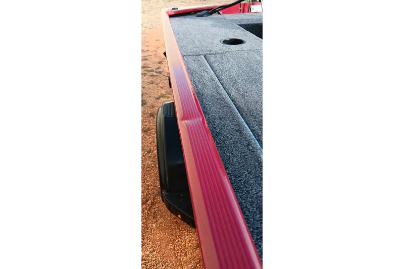 Slide: The Image of 2026 Tracker Panfish 17 boat deck with red trim and gray carpet. - 3