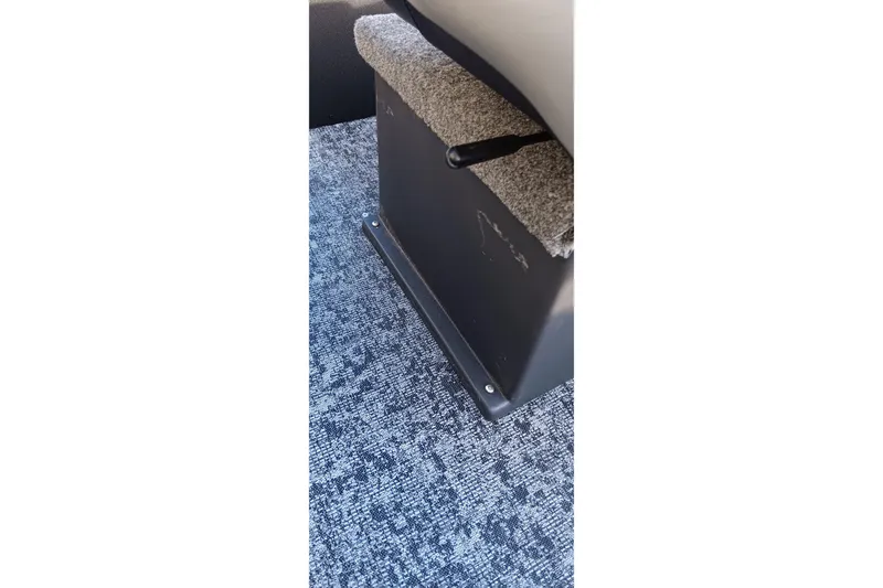 Slide: The Image of 2026 Tracker Panfish 17 boat interior with carpeted flooring and seat base. - 6