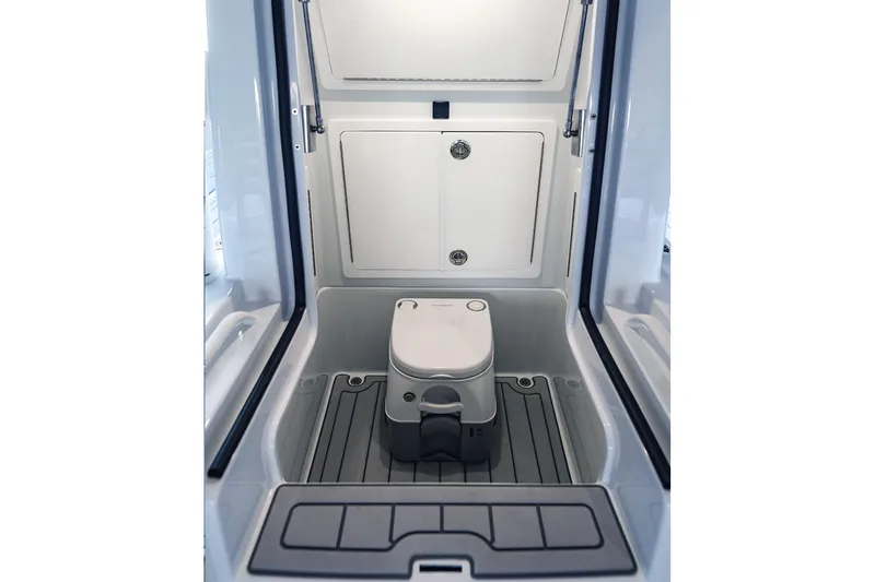 Slide: The Image of 2026 Barker Boatworks 26 Open interior with compact marine toilet and storage. - 17