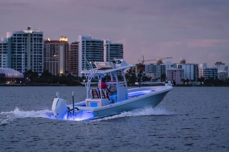 Slide: The Image of Barker Boatworks 26 Open 2026 cruising near city skyline at dusk. - 24