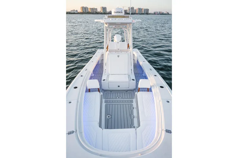 Slide: The Image of 2026 Barker Boatworks 26 Open on water, showcasing sleek design and spacious deck. - 25