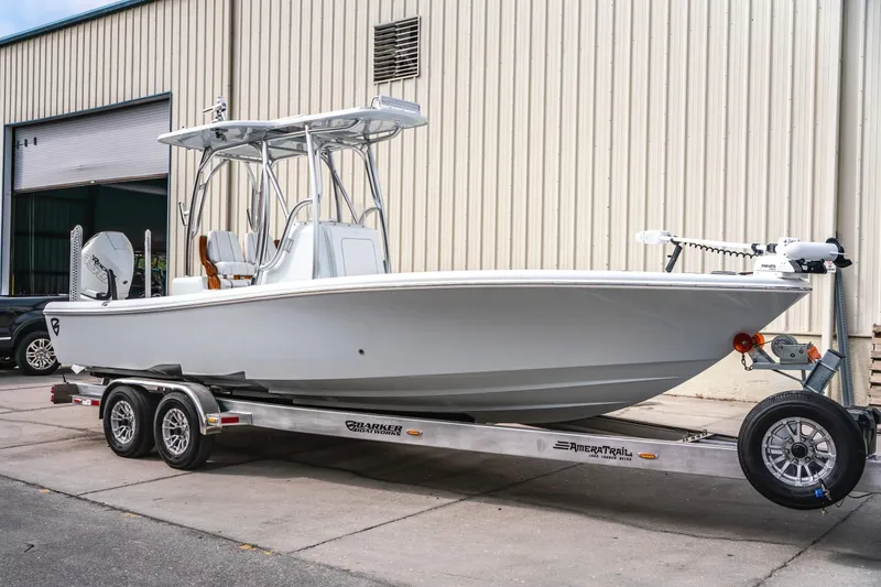 Slide: The Image of 2026 Barker Boatworks 26 Open on trailer, parked outside a warehouse. - 4