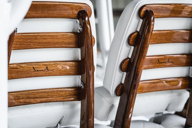 Slide: The Image of Elegant wooden and white leather seats on 2026 Barker Boatworks 26 Open. - 7