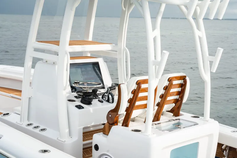 Slide: The Image of 2026 Barker Boatworks 26 Open console with wooden seats and modern controls. - 11