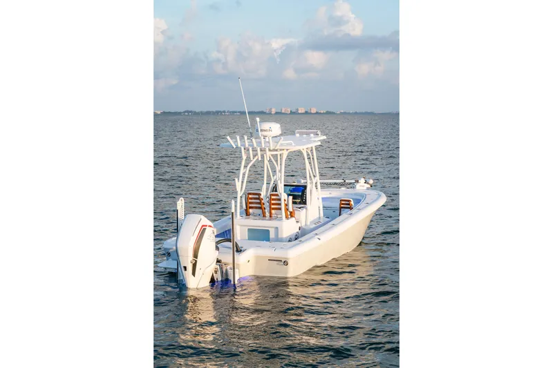 Slide: The Image of 2026 Barker Boatworks 26 Open on calm water, showcasing sleek design and modern features. - 15