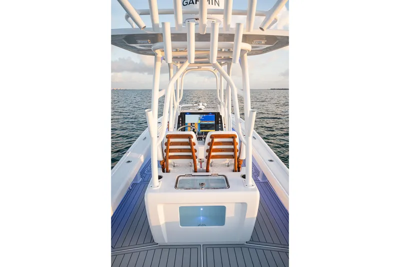 Slide: The Image of 2026 Barker Boatworks 26 Open on water, featuring helm and seating area. - 16