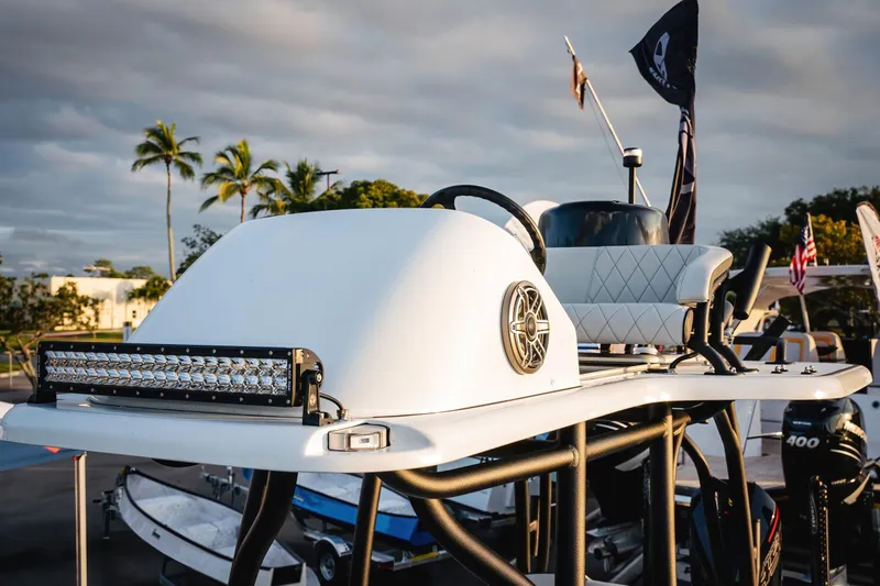 Slide: The Image of 2026 Barker Boatworks 26 Open with sleek design and advanced features, docked under palm trees. - 19