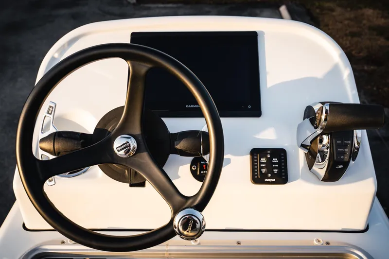 Slide: The Image of Steering console of 2026 Barker Boatworks 26 Open with modern controls and display. - 20
