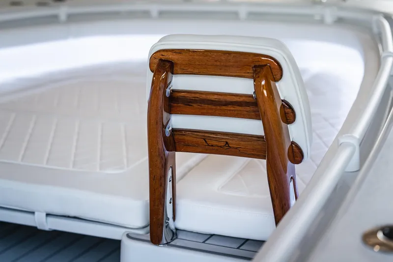 Slide: The Image of Luxurious interior of 2026 Barker Boatworks 26 Open, featuring elegant wood and white upholstery. - 8